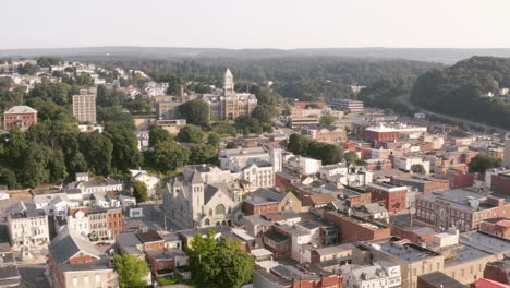 Aerial-drone-shot-flying-over-a-small-town-in-central-Pennsylvania-heading-towards-a-historic-courthouse-on-a-sunny-morning
