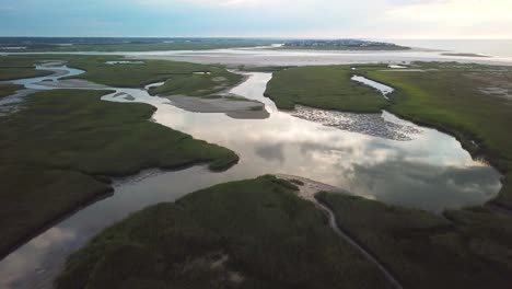 High-altitude-drone-wide-view-flyover-of-mason-inlet-marsh-and-beach-headed-towards-Figure-Eight-Island-in-Wilmington-North-Carolina