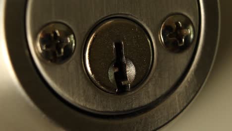 Key-Inserted-into-Deadbolt-Door-Lock-and-Turned-to-the-Left-and-Removed-Residential-Close-Up