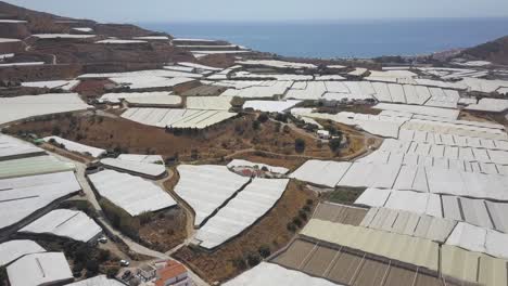 Aerial-tilt-up-shot-on-the-coast-of-Spain-full-of-greenhouses