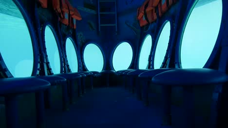 Surreal-push-in-on-the-inside-of-an-empty-submarine-and-out-one-of-the-portholes-to-the-blue-ocean-beyond