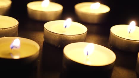 Candles-in-the-dark-rotating-dolly-slide-macro-close-up
