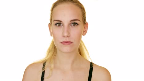 Young-woman-in-a-bra-looks-at-the-camera-with-a-serious-expression-on-her-face