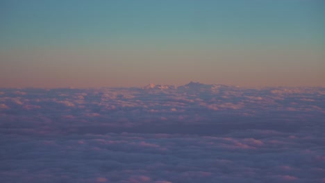 Beautiful-evening-clouds,-seen-from-as-window-in-an-airplane-are-moving-in-slow-motion