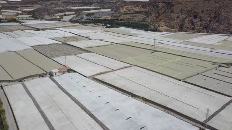 Aerial-ascending-shot-over-many-white-greenhouses-in-Almeria