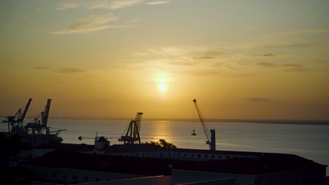 Lissabon-Hafen-Sonnenaufgang-Mit-Kranich-Silhouette-Durch-Rostige-Zäune
