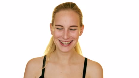 Young-blond-woman-laughing-in-the-studio-on-a-white-background