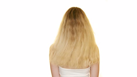 Shot-of-the-back-of-a-slim-woman-with-long-blond-hair-moving-her-hair