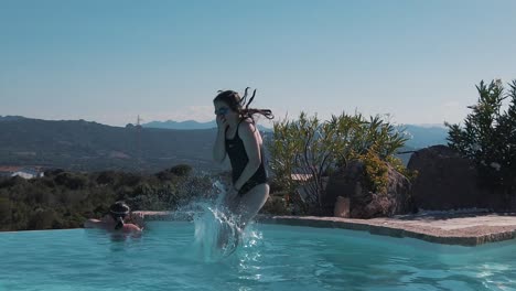 A-young-girl-jumps-in-to-an-infinity-pool