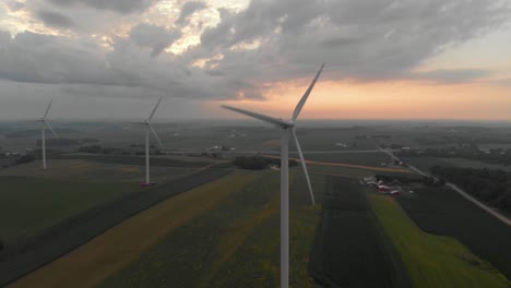 Aerial-view-of-wind-turbines-generating-power-during-beautiful-morning-sunrise-following-a-early-morning-storm