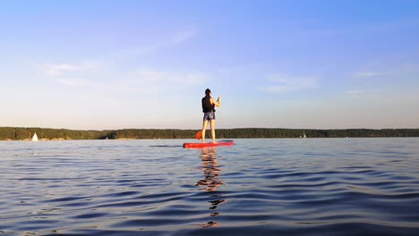 There-is-young-girl-paddle-boarding-in-the-big-lake