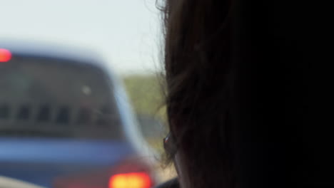 Woman-Driver-Waiting-In-Traffic-With-Head-Staring-Straight-Ahead---Close-Up-Shot