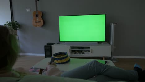 Green-Screen-TV,-Watching-at-Home-with-the-Remote-Control-in-hand