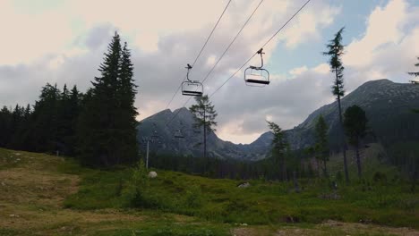 Travel-destination-out-of-season-concept,-empty-ski-lift-at-summer,-mountain-background,-Slovakia
