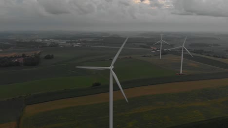 Aerial-view-of-wind-turbines-generating-power-during-a-cloudy-morning-sunrise-following-a-early-morning-storm