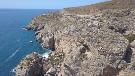 Aerial-shot-of-a-big-rocky-cliff-in-the-mediterranean-sea-in-Spain