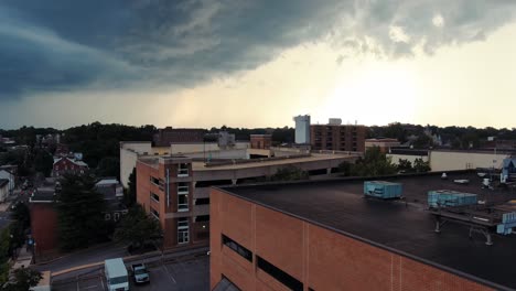 Rising-aerial-of-scary-thunderstorm-bringing-rain,-wind,-thunder,-lightning-above-Lancaster-City,-Pennsylvania-urban-setting