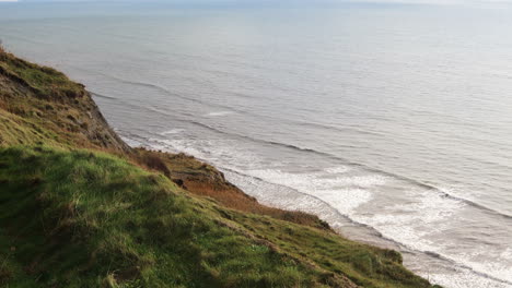 Charmouth,-Devon-Grassy-Cliff-Edge-With-Waves-Crashing-Below