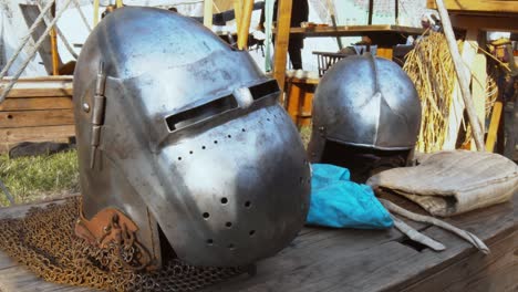 A-table-with-headwear-for-a-knight-at-a-medieval-festival