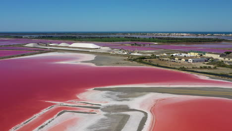 The-historical-town-of-Aigues-Mortes-in-the-Camargue,-France-during-a-sunny-summer-day-which-is-located-next-to-a-pink-salt-lake