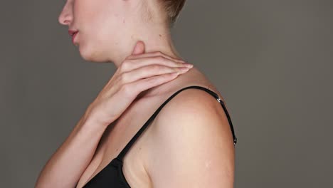 Close-up-on-the-neck-of-a-woman-feeling-pain-and-massaging-herself-with-her-hand-to-cause-relief