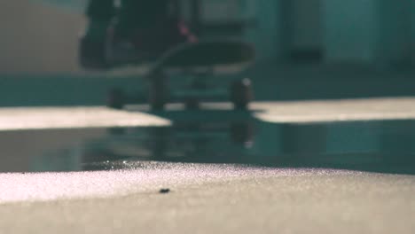 Skateboard-splashes-through-water-puddle