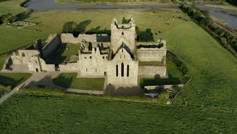Aerial-view,-tilt-down,-Dunbrody-Abbey-is-a-former-Cistercian-monastery-in-County-Wexford,-Ireland