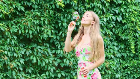 A-beautiful-woman-in-the-park-is-playing-by-blowing-soap-bubbles