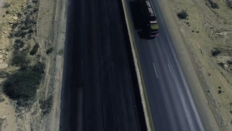 A-slow-mo-aerial-top-view-of-a-heavy-truck-moving-on-a-highway-in-northern-areas