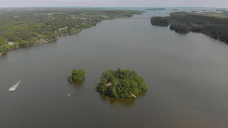 Drone-shot-of-a-small-island-in-the-centre-of-a-lake