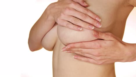 Close-up-of-a-woman's-large-breasts-with-her-hands-nipples-covered-during-a-BSE
