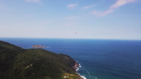 Aerial-Tracking-Shot-of-Paramotor-Flight-in-Beach-with-Blue-Sky