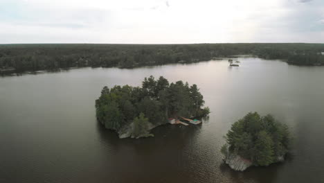 Drone-shot-of-a-small-private-island-with-a-cottage