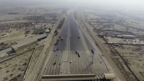 Aerial-view-of-a-motorway-toll-plaza-of-the-city,-Heavy-vehicles-and-others-entering-and-crossing