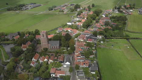 Aerial-approach-and-top-down-view-of-the-village-Ransdorp-with-its-agrarian-surroundings-near-the-city-of-Amsterdam-in-The-Netherlands-with-clouds