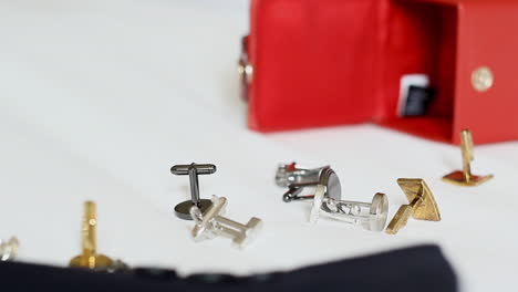 cufflinks-spilled-out-on-the-bed