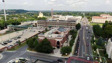 Aerial-drone-view-of-town-in-Hershey-Pennsylvania,-tracking-street-and-panorama-on-sunny-summer-day