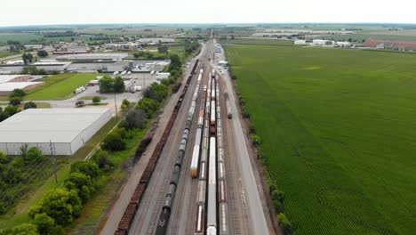 4k-aerial-view-showing-multiple-trains-parked-at-a-train-station-waiting-to-leave