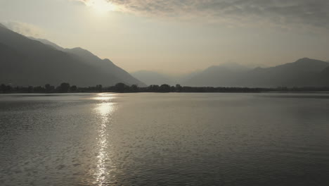 Aerial-dolly-of-the-Lago-Maggiore-during-sunrise,-Switzerland