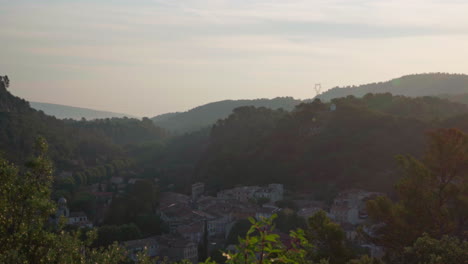 A-slow-pan-in-the-morning-over-a-village-located-in-a-valley-in-the-Cote-d'Azur-region-in-France