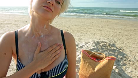 Eine-Frau-Mit-Empfindlicher-Haut-Gegenüber-Sonnenwärme,-Die-Die-Sonnencreme-Auf-Ihre-Brust-Aufträgt-Und-Die-Zarte-Berührung-Ihrer-Finger-Genießt