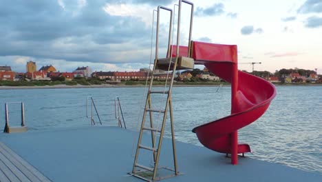 Red-waterslide-on-a-bridge-by-the-sea-on-the-coast-of-Sweden