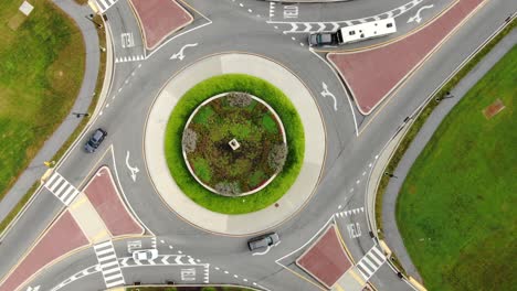 Aerial-top-down-orbiting,-rotating-drone-view-of-traffic-circle-roundabout