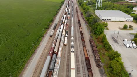 4k-aerial-view-showing-multiple-trains-parked-at-a-train-station-waiting-to-leave