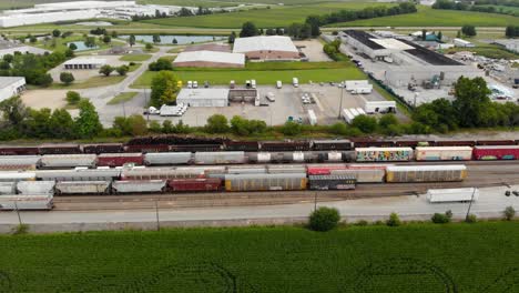 4k-aerial-view-panning-left-to-right-of-multiple-trains-and-one-starting-to-leave-the-train-station