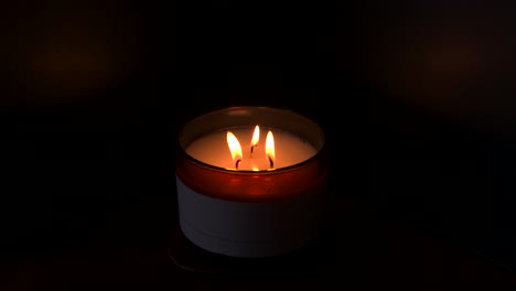 4K,-slow-mo,-three-candles-burning-with-dark-background