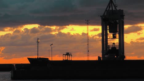 Time-lapse-with-a-cargo-ship-and-a-crane-in-the-foreground-on-the-coast-of-Sweden