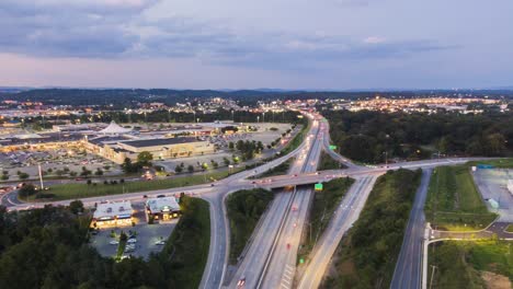 Aerial-drone-hyperlapse-timelapse,-Route-30-highway-in-Lancaster,-Pennsylvania-with-shopping-mall-and-park-in-view