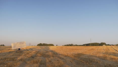 Walking-With-Plywood-Sheet-in-The-Field-Blue-Sky-Sunset