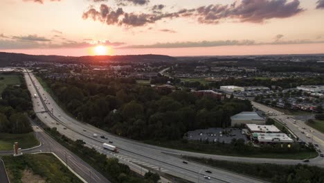 Beautiful-colorful-sunset-over-Lancaster-County,-Pennsylvania,-USA-highway,-aerial-drone-timelapse,-hyperlapse-of-traffic-moving